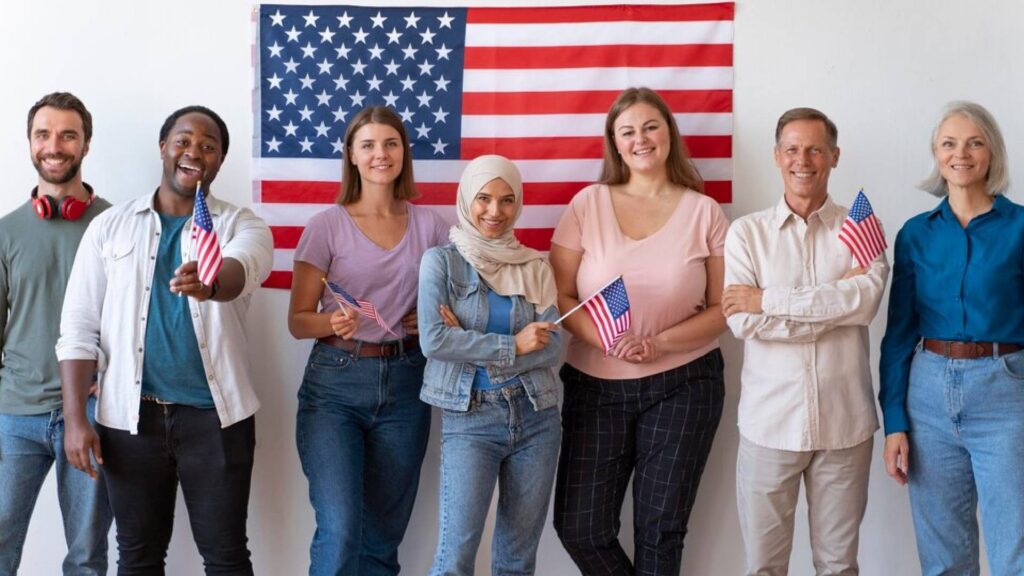 Diverse group of people holding American flags, symbolizing unity and innovation in the USA. Perfect representation for choosing the right mobile app development company in the USA for startups."